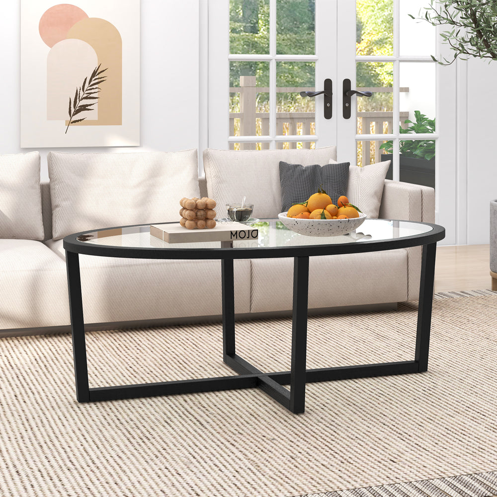 Oval glass coffee table showcasing a spacious top for decorations, featuring a sleek design with curved edges for.