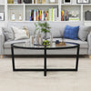 Oval glass coffee table with black cross base and acacia wood legs, perfect for living room decor and functionality.