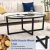 Oval glass coffee table with solid acacia wood legs and cross base, designed for stability and easy cleaning in living.