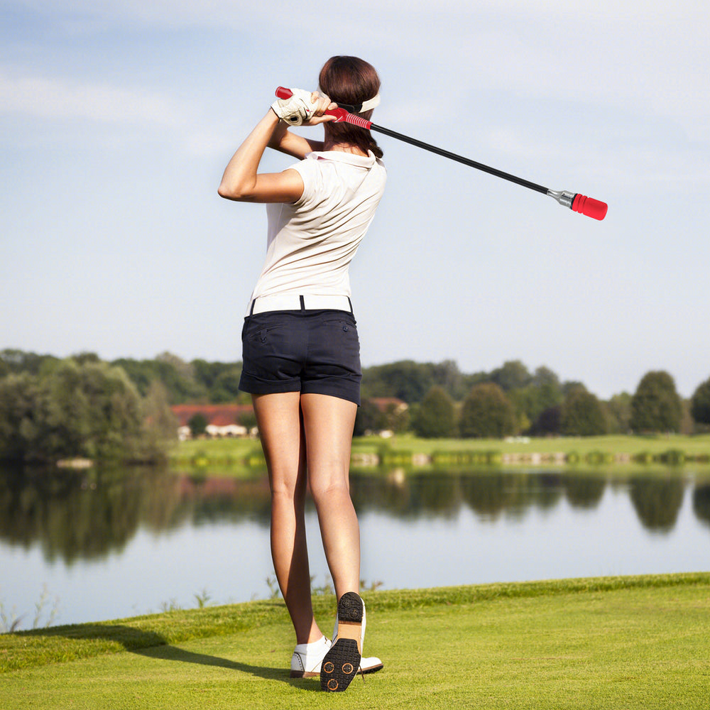Golf Swing Trainer Click Stick in use, featuring a red foam headcover and fiberglass shaft for optimal flexibility and.