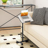 Gray overbed rolling table with adjustable height, 360° rotating tabletop, and wheeled base for versatile use.