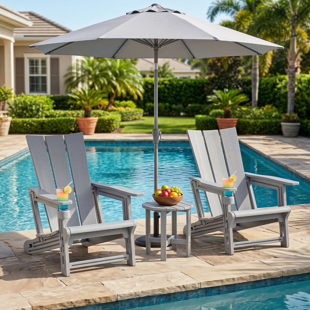 Two gray HDPE outdoor Adirondack chairs with cup holders beside a pool, perfect for relaxing in style.