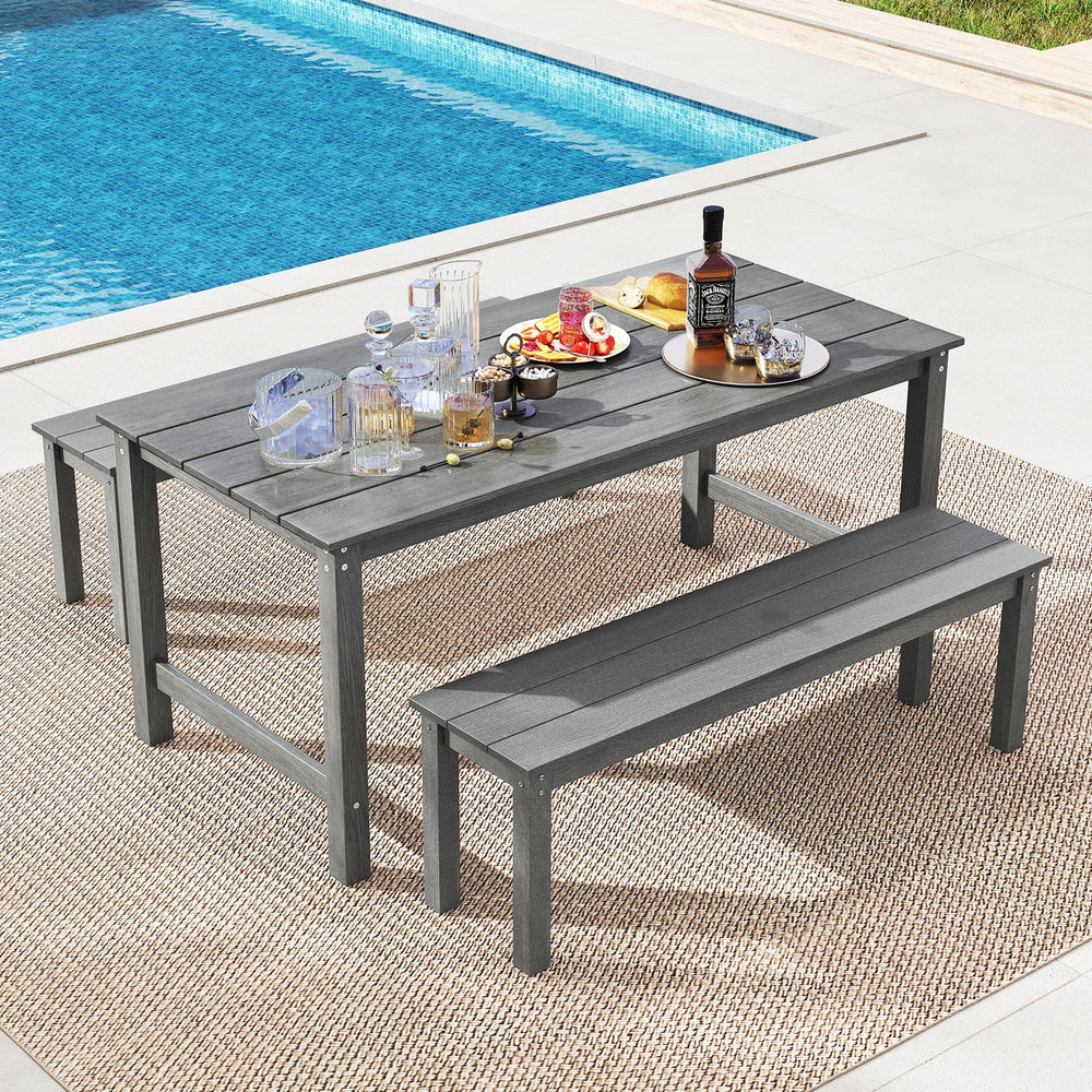 Gray HDPE outdoor dining table for 6 with wood-like tabletop and umbrella hole, perfect for patio or poolside.