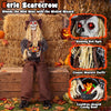 Eerie sitting scarecrow with glowing red eyes and cauldron-shaped candy bowl, perfect for Halloween trick-or-treaters.