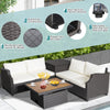 7-piece hand-woven wicker outdoor furniture set with white cushions and acacia wood coffee table for stylish relaxation.