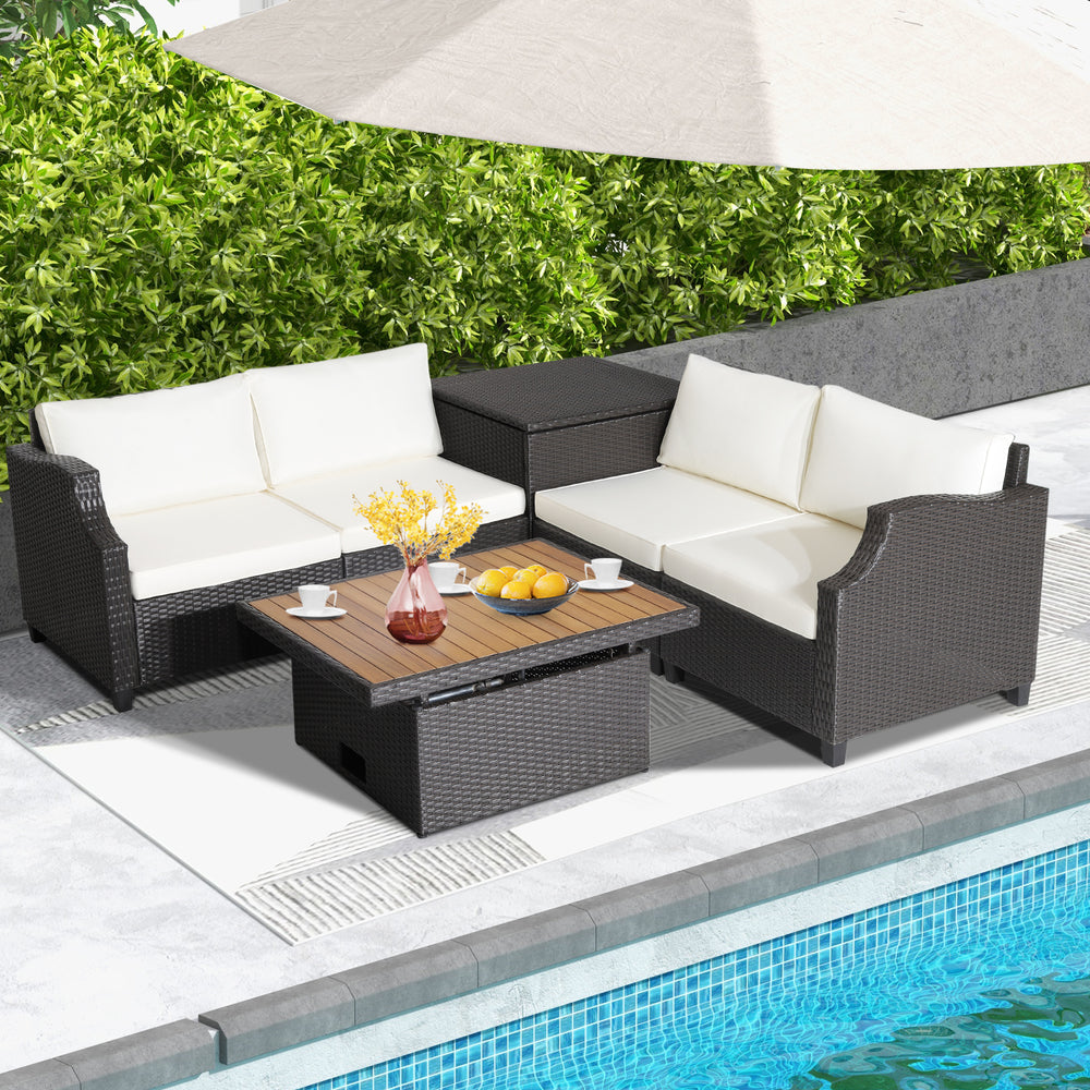 Hand-woven wicker outdoor furniture set with white cushions and acacia wood coffee table, perfect for poolside.