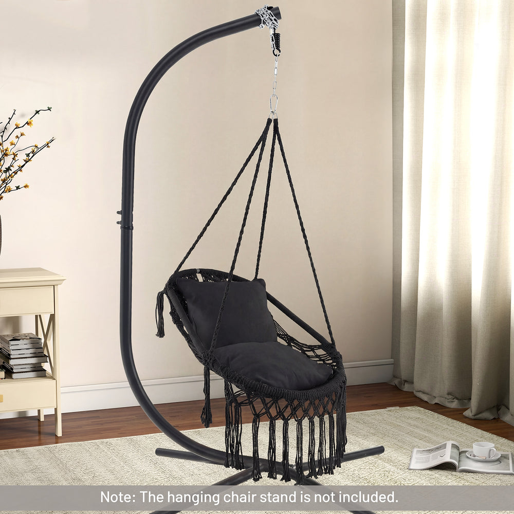 Hanging hammock chair in black with soft cushions and elegant tassels, suitable for indoor and outdoor use.