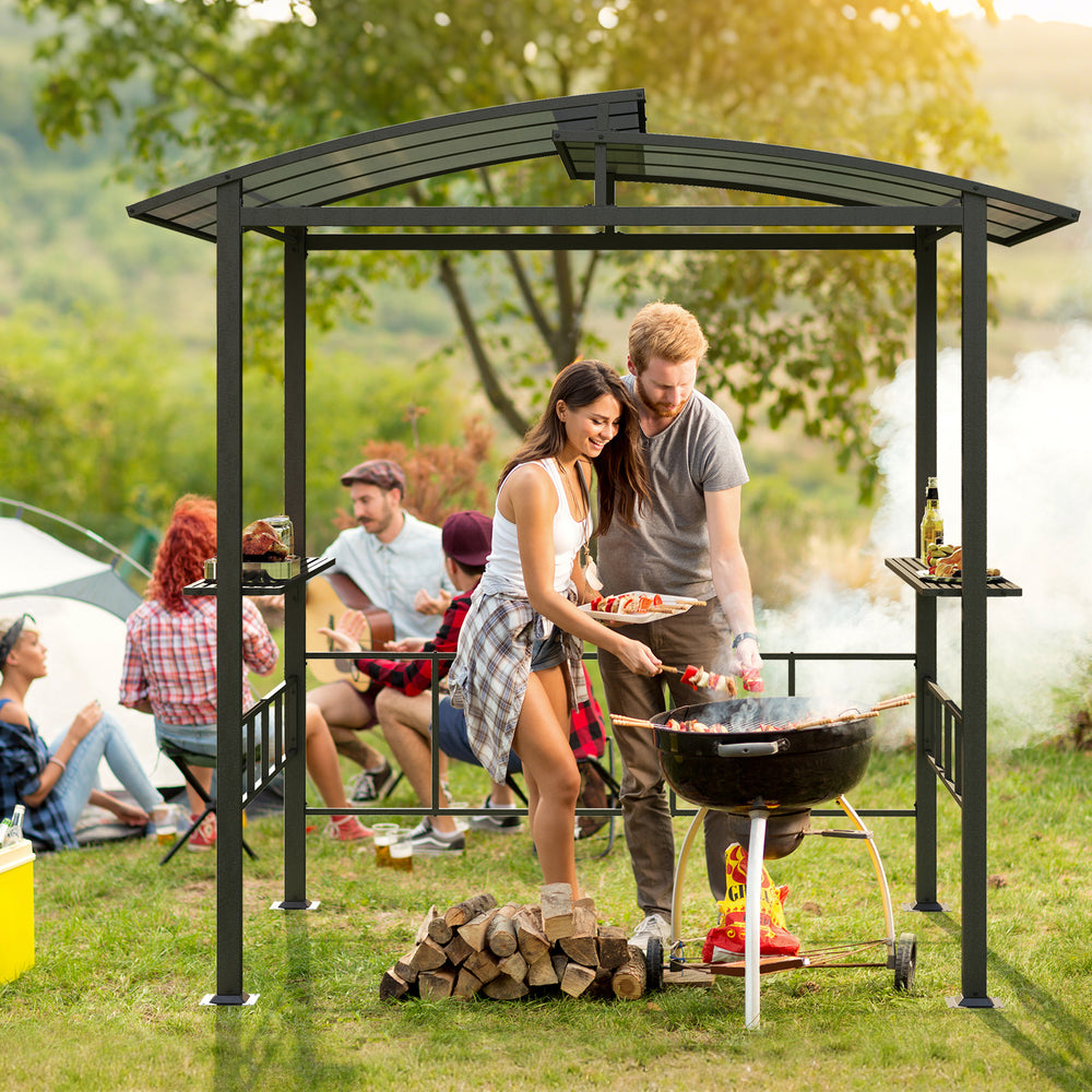 Hardtop grill gazebo with vented polycarbonate roof and side shelves, perfect for outdoor cooking and gatherings.