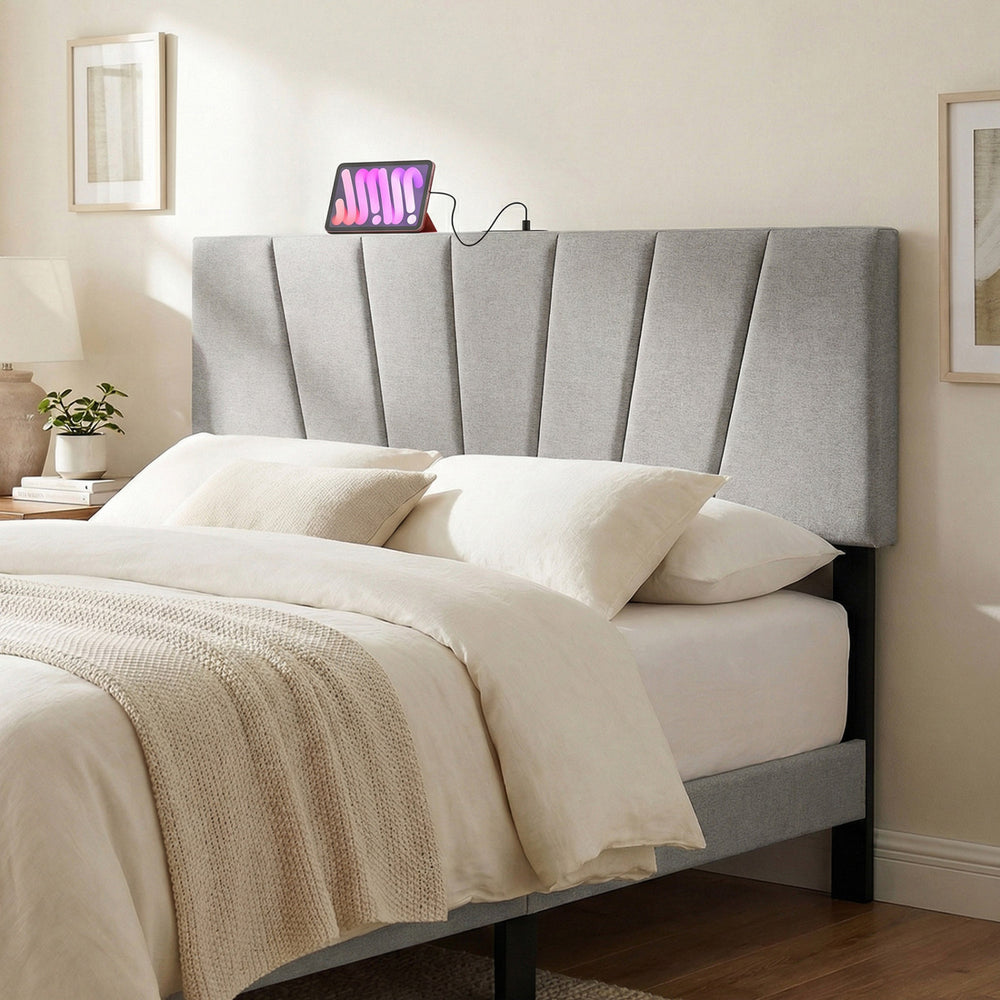 Geometric gray upholstered headboard for queen and full size beds with USB and AC outlets for convenient charging.
