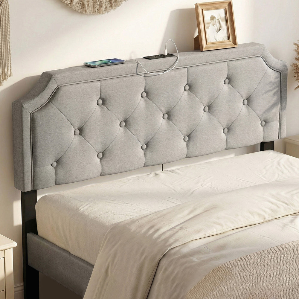 Tufted gray upholstered headboard for queen and full size beds, featuring charging ports and rubber wood legs.