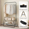 Heavy duty black clothes rack with hanging rod and two storage shelves, featuring anti-fall devices for secure storage.