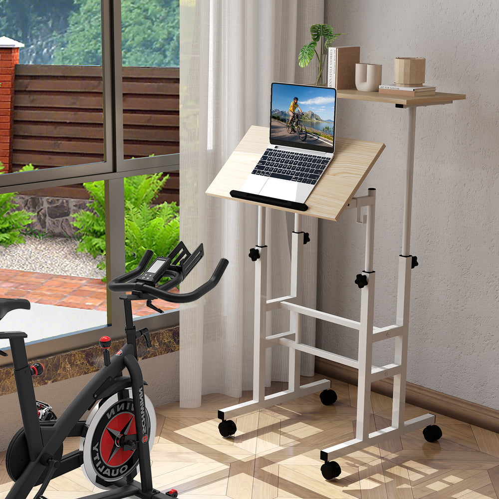 Height-adjustable mobile standing desk with split top, featuring a tilting surface for comfortable typing and reading.
