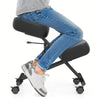 Height adjustable kneeling chair with thick padded cushions for posture correction, shown in use with a person seated.