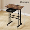Height adjustable laptop desk in rustic brown with a fabric drawer, lockable wheels, and a spacious tabletop for versatile use.