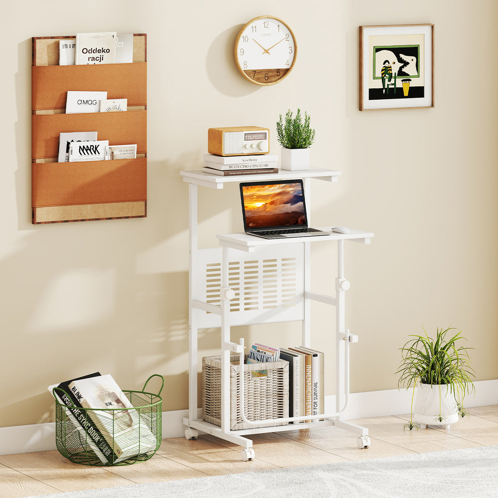Height adjustable mobile computer stand-up desk in white with wheels, featuring a top shelf and bottom storage for.