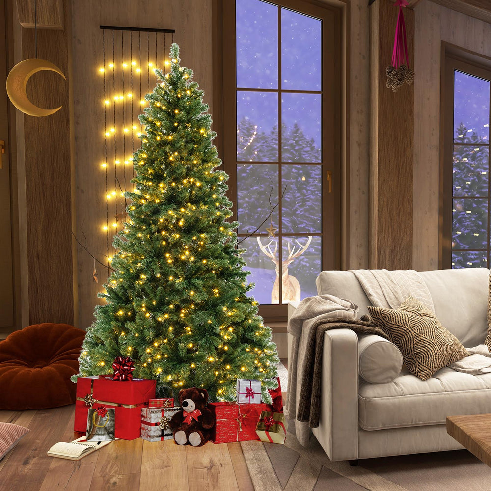 7 ft hinged Christmas tree with warm white LED lights, PVC branch tips, and gifts, perfect for holiday decor.