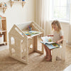 House-shaped wooden kids table and chair set in natural finish, ideal for reading and creative play in a cozy room.