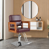Hydraulic barber chair with red PVC leather, wooden armrests, and 360-degree swivel for hair styling convenience.