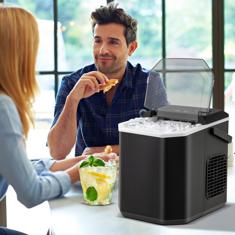 Countertop ice maker in black producing bullet-shaped ice, ideal for home kitchen or party use, with self-cleaning.