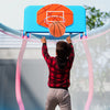 Kids trampoline with pink frame and basketball hoop, featuring a 48" jumping surface for indoor and outdoor fun.