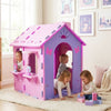 Colorful indoor cottage playset in pink and purple with kids playing, featuring a chimney and storage shelves for toys.