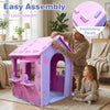 Indoor cottage playset in pink and purple with interlocking panels, featuring a chimney and shelves for creative play.