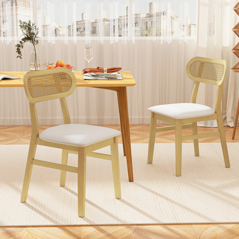 Set of 2 indoor mid-century wood dining chairs with rattan backrest and white PU leather seats for modern dining rooms.