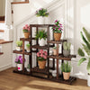 Multi-tiered brown wood plant stand with 6 shelves, displaying potted plants, ideal for indoor and outdoor use.