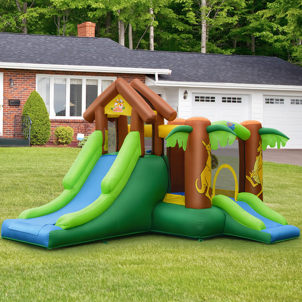 Kids inflatable jungle bounce house with slides and climbing wall, made of durable PVC fabric for outdoor fun.
