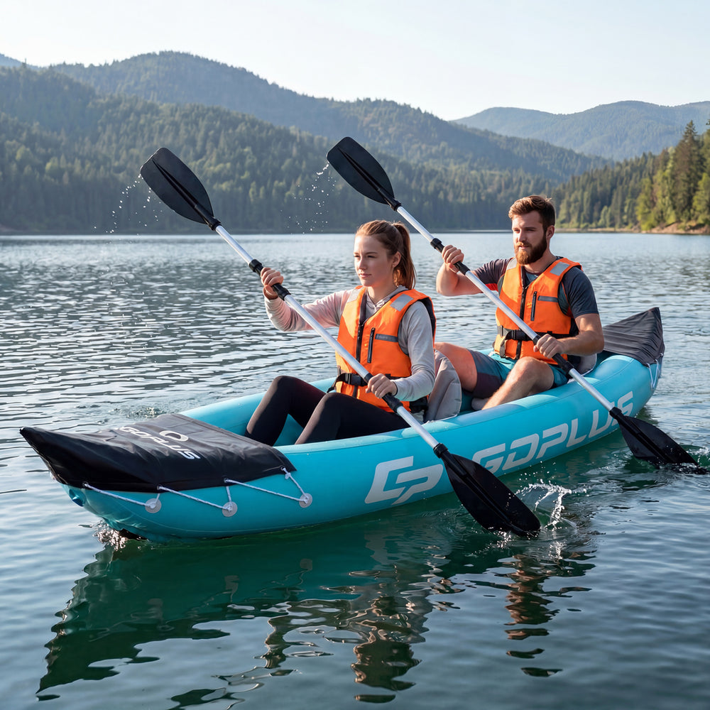 Two people paddling the blue inflatable tandem kayak on a calm lake, featuring heavy-duty design and aluminum paddles.