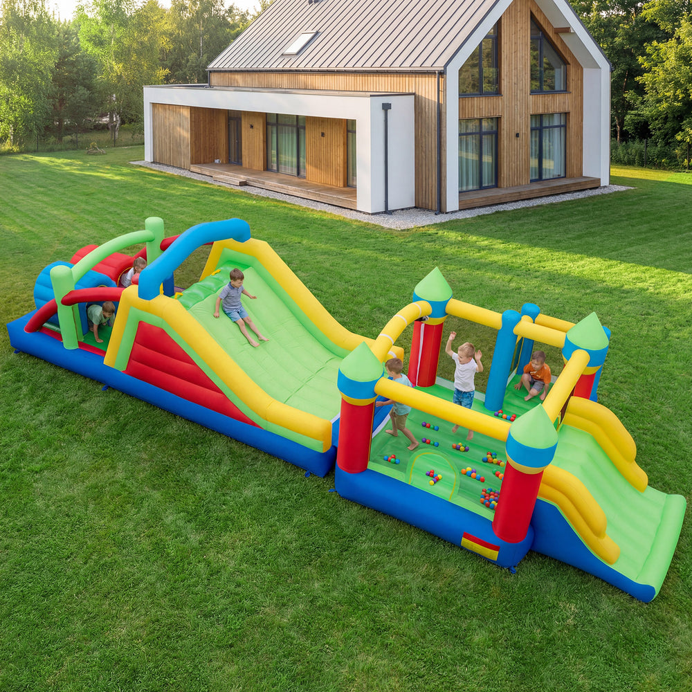 Inflatable obstacle course bounce house with dual slides and tunnels, perfect for backyard fun and competitive play.