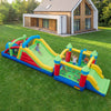 Inflatable obstacle course bounce house with dual slides, climbing wall, and tunnels for outdoor fun and play.