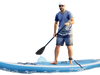 Inflatable stand up paddle board in use on water, featuring a stylish coco motif and adjustable aluminum paddle.