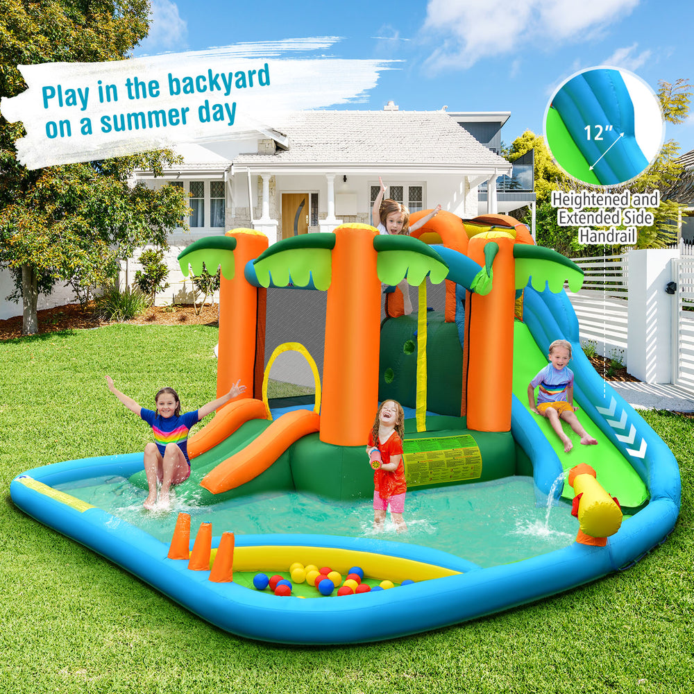 Inflatable water slide park with palm trees, two slides, and splash pool for kids' summer fun in the backyard.