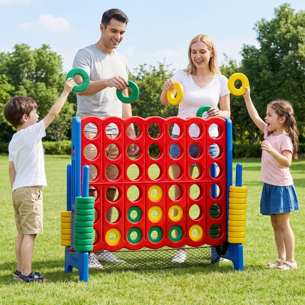 Jumbo 4 in a Row game set with family playing outdoors, featuring colorful chess pieces for fun group activities.
