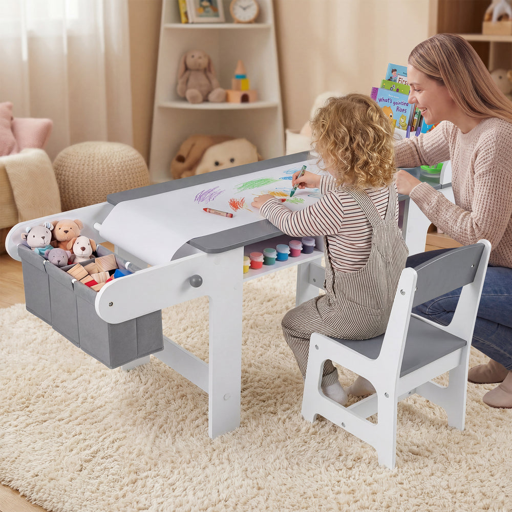 Kids art table and chair set in gray with paper roll, fabric bins, and ample storage for drawing and playing activities.