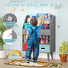 Kids bookshelf in gray with open compartment, 3-tier design, and safety features for toddlers in a playful room setting.