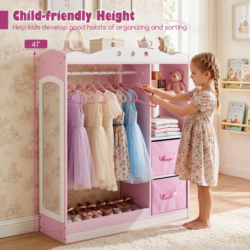 Kids dress up storage in pink with full-length mirror, hanging rod, and open shelves for easy access and organization.