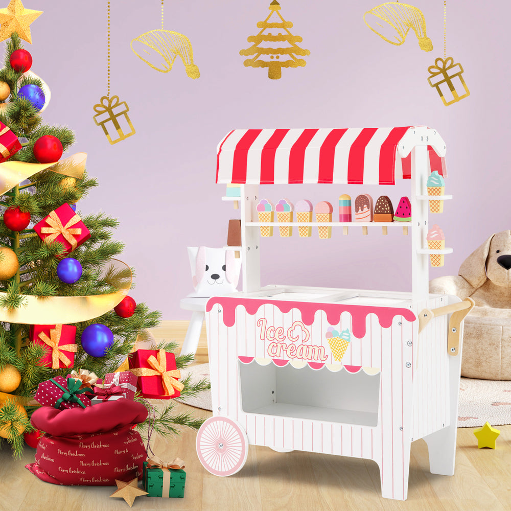 Kids ice cream cart playset in red with 12 accessories, featuring a display rack and large wheels for easy mobility.