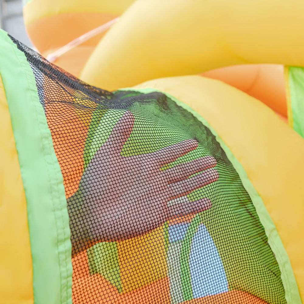 Close-up of a hand on the mesh netting of a kids inflatable water slide, featuring vibrant colors and safe play design.
