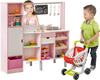 Two children playing with the 2-in-1 pink kitchen and market set, showcasing its interactive features and ample storage.