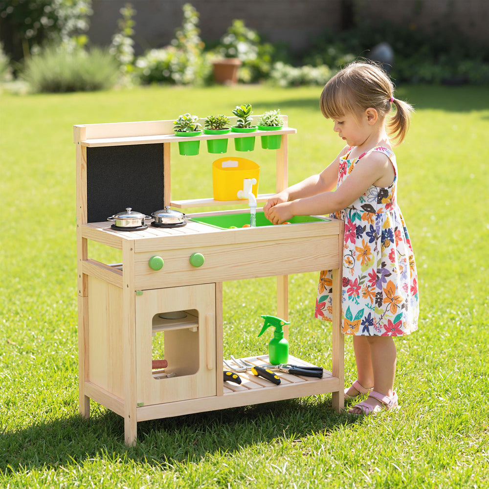 Kids mud kitchen playset with chalkboard, stainless steel utensils, and sink for imaginative outdoor cooking fun.