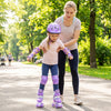 Adjustable purple kids roller skates with light-up wheels, worn by a child, for fun and safety during outdoor skating.