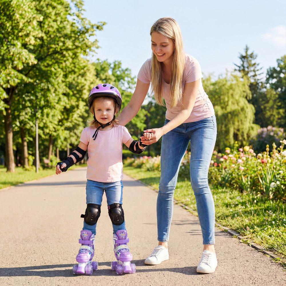 Toddler wearing purple adjustable roller skates with light-up wheels, assisted by an adult in a park setting.