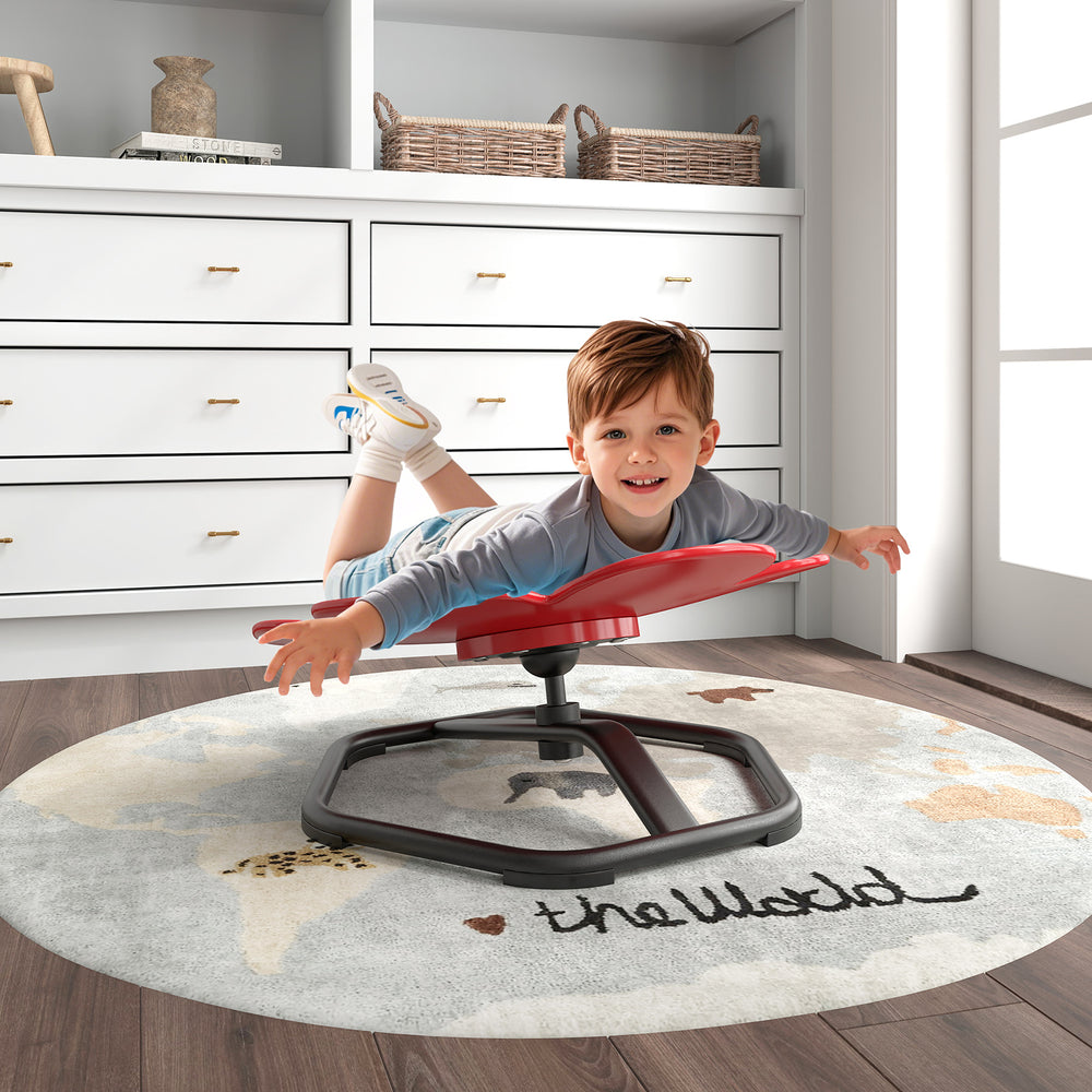 Child enjoying the red kids sensory swivel chair, lying down playfully while enhancing coordination and balance.