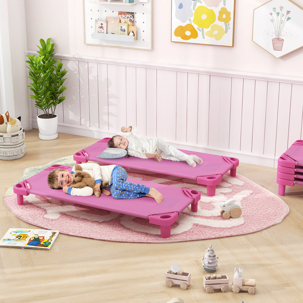 Two kids resting on pink stackable daycare cots with detachable Oxford cloth, ideal for daycare or playroom use.