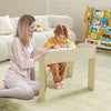 Kids table and chair set in white with wide tabletop and curved edges, perfect for playtime and learning in a child's.