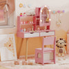 Kids vanity set in pink featuring a lighted mirror, storage drawers, and a chair, perfect for pretend play and dressing.