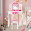 Kids vanity table and stool set in pink with polka dot print, featuring a tri-fold mirror and ample storage for.