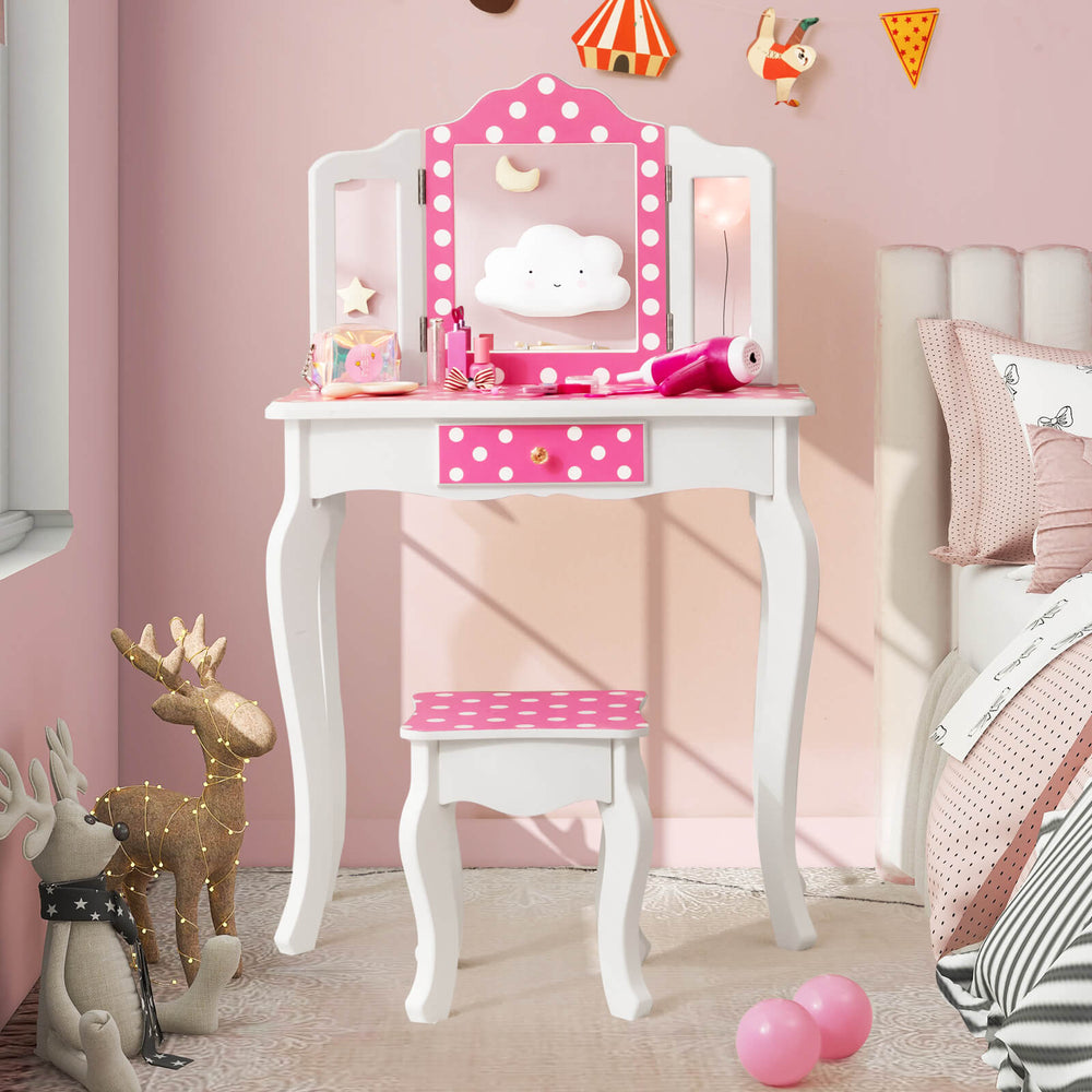 Kids vanity table and stool set in pink with polka dot print, featuring a tri-fold mirror and ample storage for.